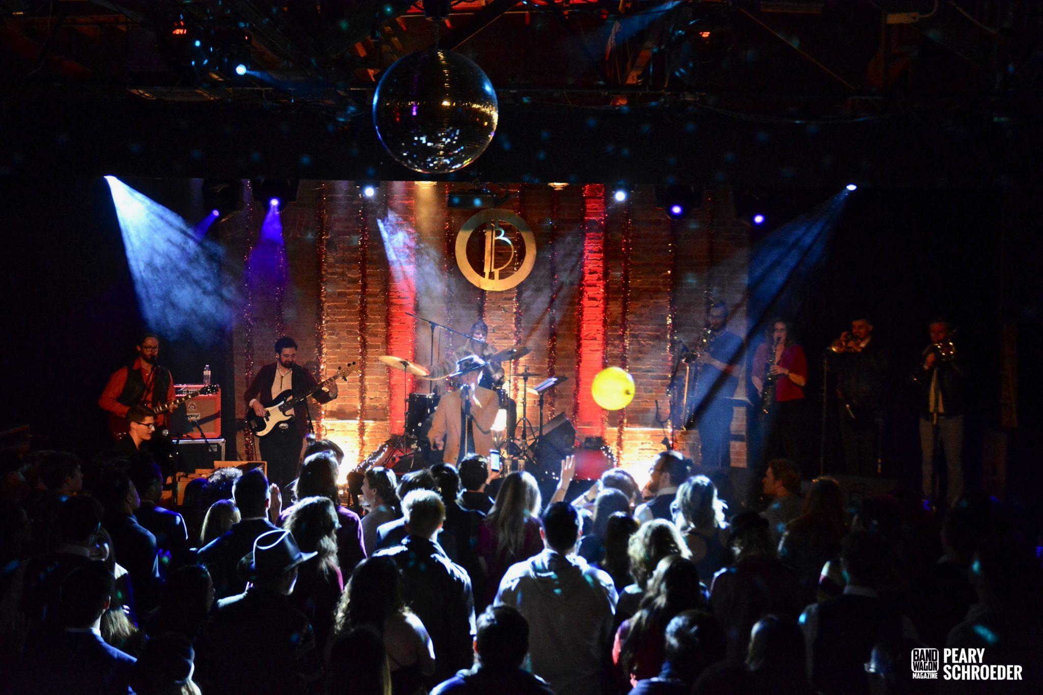 The Burroughs performing under the Moxi mirrorball